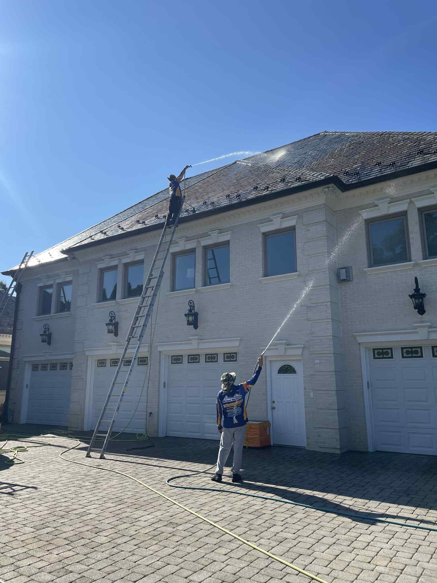 HOA building exterior cleaning shine select employees pressure washing the exterior of an HOA community building